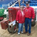 Photo of couple in front of a tractor