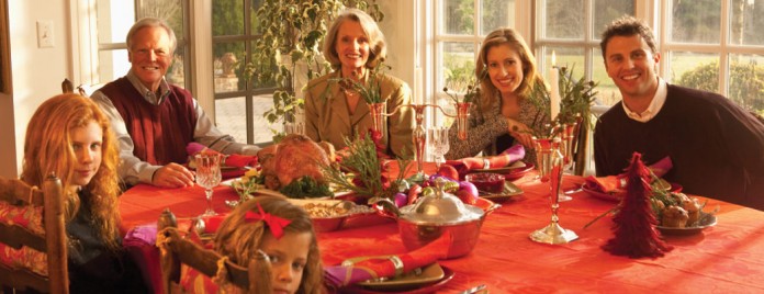 family gathered around Thanksgiving table family gathered around Thanksgiving table