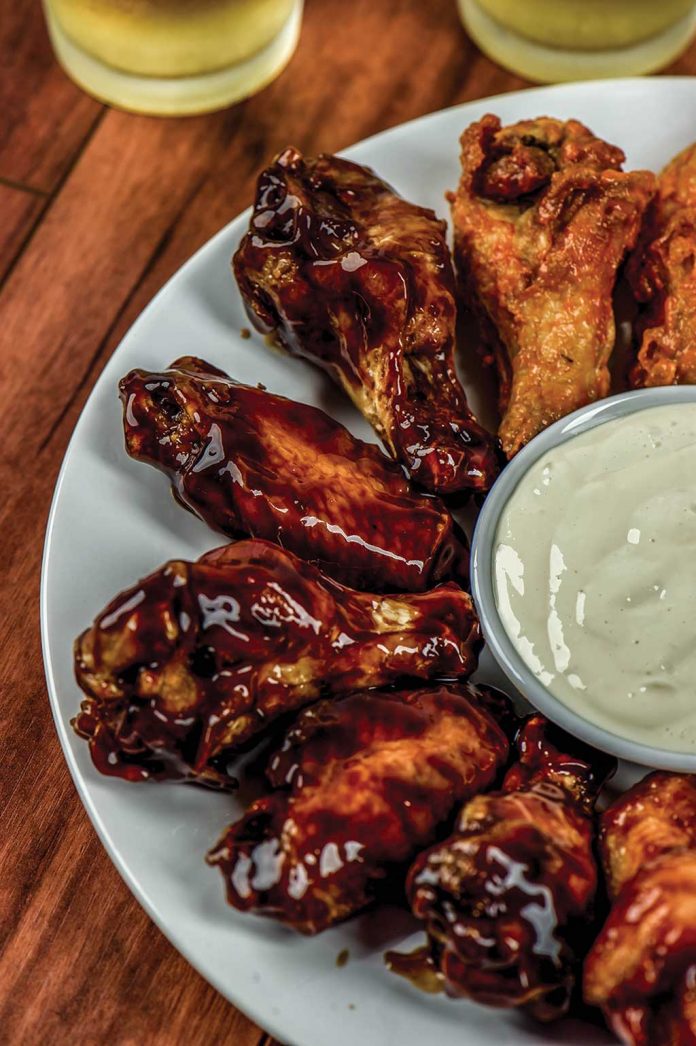 Teriyaki Chicken Wings Teriyaki Chicken Wings on a plate with Ranch Dressing in a bowl in the middle of the wings.