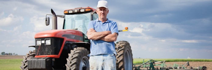 Farmer Farmer standing by tractor