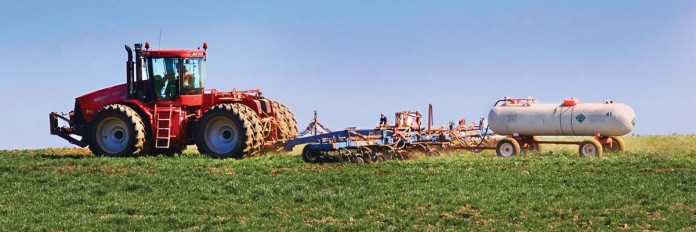 Tractor spreading fertilizer