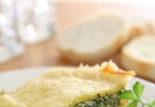 Four Cheese Spinach Lasagna with White Sauce A piece of Four Cheese Spinach Lasagna on a white dinner plate.