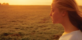 Building character starts in childhood girl and sunset over farmland
