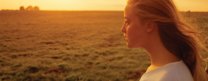girl and sunset over farmland