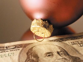 Seven simple ways to spend less this season Christmas bulbs and $100 bill