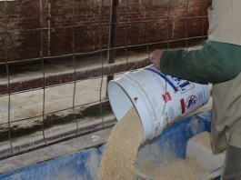 inmate pouring feed