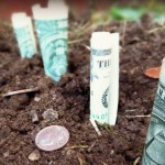 Grants for farmers dollar bills and coins in soil