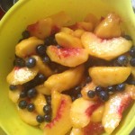 blueberries and peaches in mixing bowl