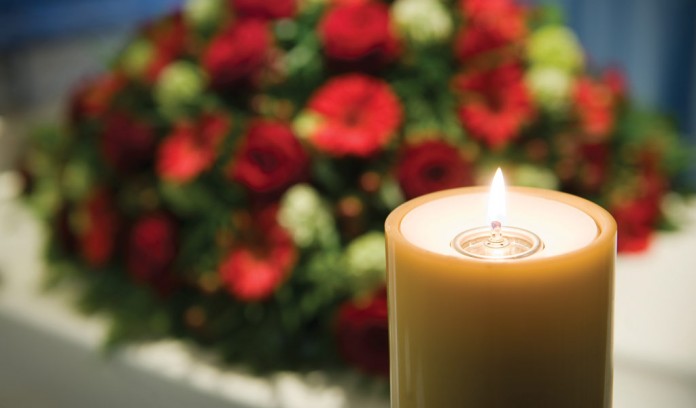 funeral flowers and candle