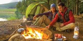 couple sitting by campfire
