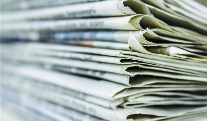 newspaper pile/Susan Crowell column