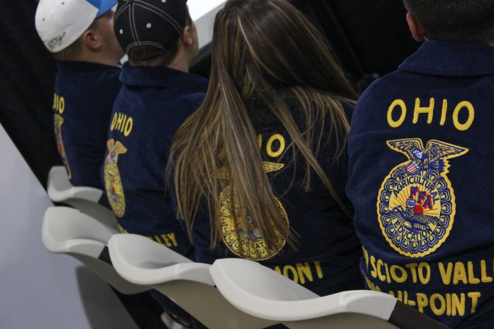Ohio FFA convention FFA members sit next to each other in chairs.