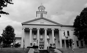 The tall clock tower and looming white pillars of the Lawrence County, Pennsylvania Courthouse stands tall against the cloudy sky as another day in Drug Court begins.