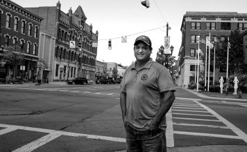 Brent Bennet stands on the corner of a Huron County street