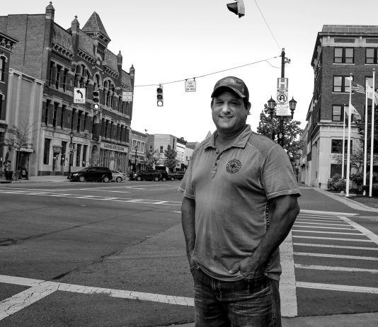 Brent Bennet stands on the corner of a Huron County street
