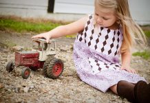 The search for toy tractors Little girl