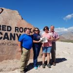 Hiking in the Red Rock with the Bates and Tracy families The Bates and Tracy Families pose in front of the entrance for Red Rock Canyon National Park with the Farm and Dairy paper in hand.