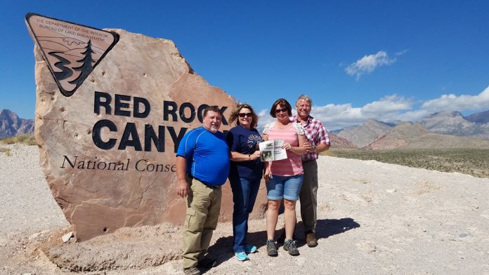 vac_bates The Bates and Tracy Families pose in front of the entrance for Red Rock Canyon National Park with the Farm and Dairy paper in hand.