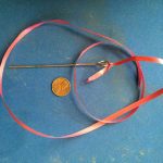 Can you identify this antique pin’s use or will you get stuck? Antique pin about 6 inches long with a large rounded opening at the one end.