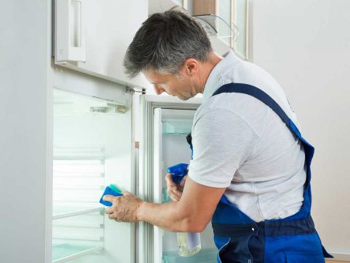 Man cleaning fridge