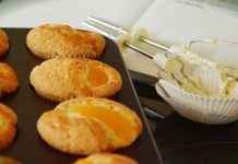 Cranberry Orange Muffins Cranberry Orange Muffins in baking pan with beaters and cookbook in the background