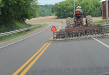 7 safety tips for driving farm equipment on the road tractor on the road
