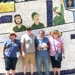 The Paglialungas tour the sites of Havana, Cuba with the Farm and Dairy Joyce and John Paglialunga and their children, John and Jeana, stand in front of a mosaic wall depicting Fidel Castro and Guerrillero Heroico.