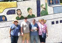 The Paglialungas tour the sites of Havana, Cuba with the Farm and Dairy Joyce and John Paglialunga and their children, John and Jeana, stand in front of a mosaic wall depicting Fidel Castro and Guerrillero Heroico.