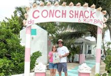 The Willoughbys took us to Turks and Caicos! The Willoughbys at the entrance to Da Conch Shack on Turks and Caicos holding a Farm and Dairy Newspaper