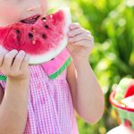 little girl eating watermelon