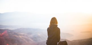 girl sitting on mountain