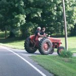 Two riders on tractor