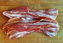 W.Va. man charged with felony over bacon theft Bacon layed out on a cutting board to be chopped into pieces for Pigskin Bites