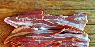 W.Va. man charged with felony over bacon theft Bacon layed out on a cutting board to be chopped into pieces for Pigskin Bites