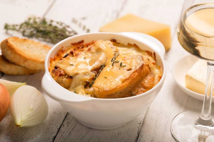 French Onion Soup A bowl of French Onion Soup surrounded by onions, crostinis and cheese
