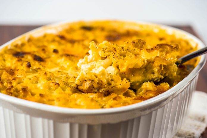 Macaroni & Cheese A white casserole dish filled with Macaroni & Cheese