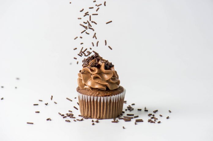 Chocolate Cupcake with Chocolate Cream Cheese Frosting and Chocolate Sprinkles dropping over the top. Chocolate Cupcake with Chocolate Cream Cheese Frosting and Chocolate Sprinkles dropping over the top.