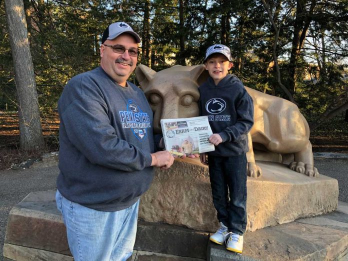 Halls visiting Penn State with their Farm and Dairy Dennis Hall standing in front of the Nitany Lion Statue at Penn State with his nephew, Jake and his Farm and Dairy.