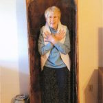 A lighthearted Hazard a Guess, Can you name this antique find? A woman stands inside of a large opening in this antique item.