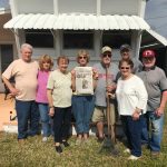 Vacationing in Palmetto, Florida Vacationing in Palmetto, Florida a group of friends stands in front of a window with an awning