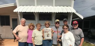 Vacationing in Palmetto, Florida a group of friends stands in front of a window with an awning