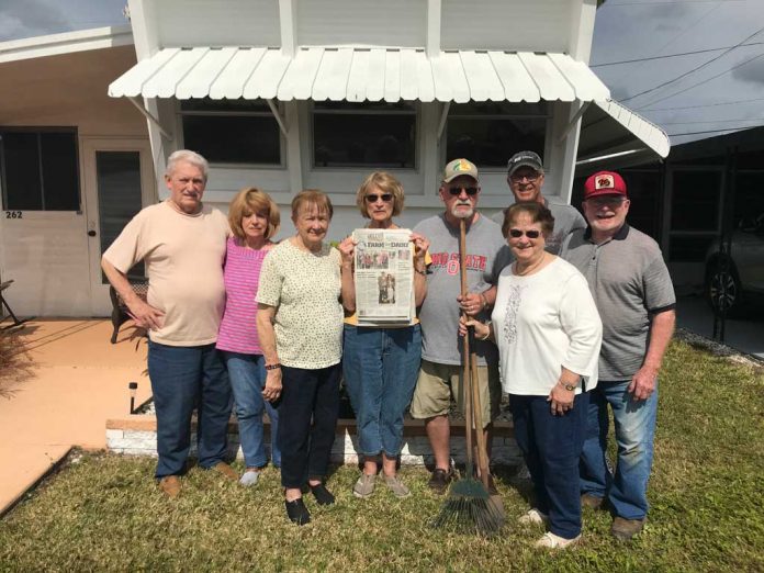 Vacation With Us - Kirk Vacationing in Palmetto, Florida a group of friends stands in front of a window with an awning