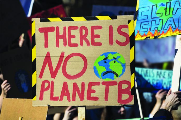 Protestors holding climate change banners at a protest