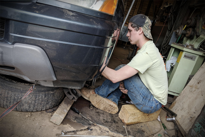 BoyWonder repairing his vehicle BoyWonder repairing his vehicle