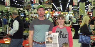 The Hays family stands with their Farm and Dairy Newspaper at the National Farm Machinery Show