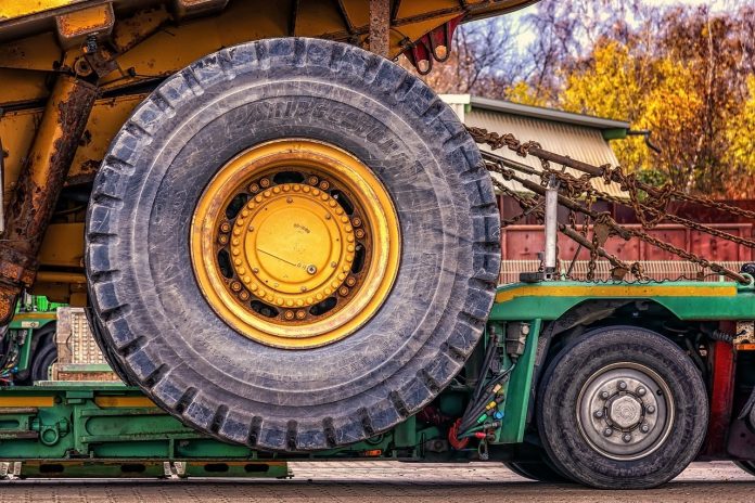 wheel of a construction tractor strapped down wheel of a construction tractor strapped down