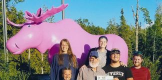 The Rhoades family pose in front of the Pink Moose statue on Mackinaw Island