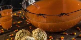 Caramel Popcorn Balls decorated for halloween with plastic spiders