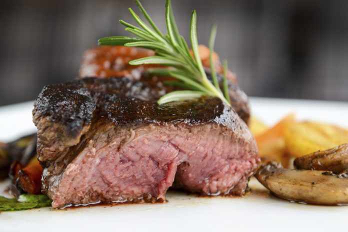 feature.web Medium Rare Venison Steak plated with potatoes and rosemary