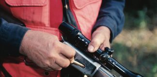 hunter loading rifle orange vest